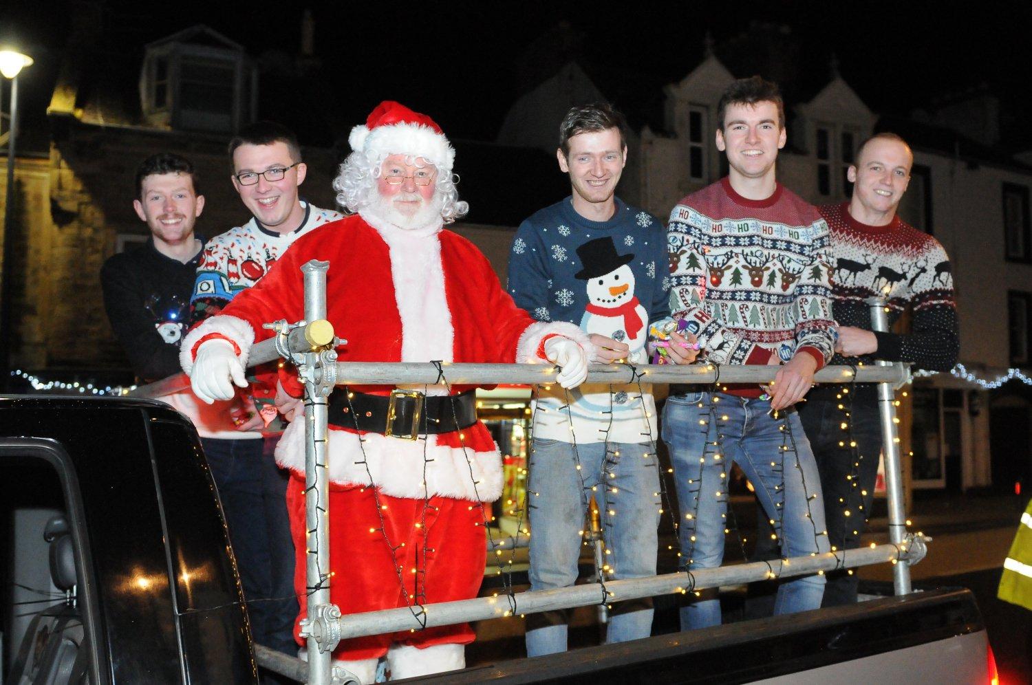 Santa arrives with his helpers, standard bearer Craig Monks and his attendants.