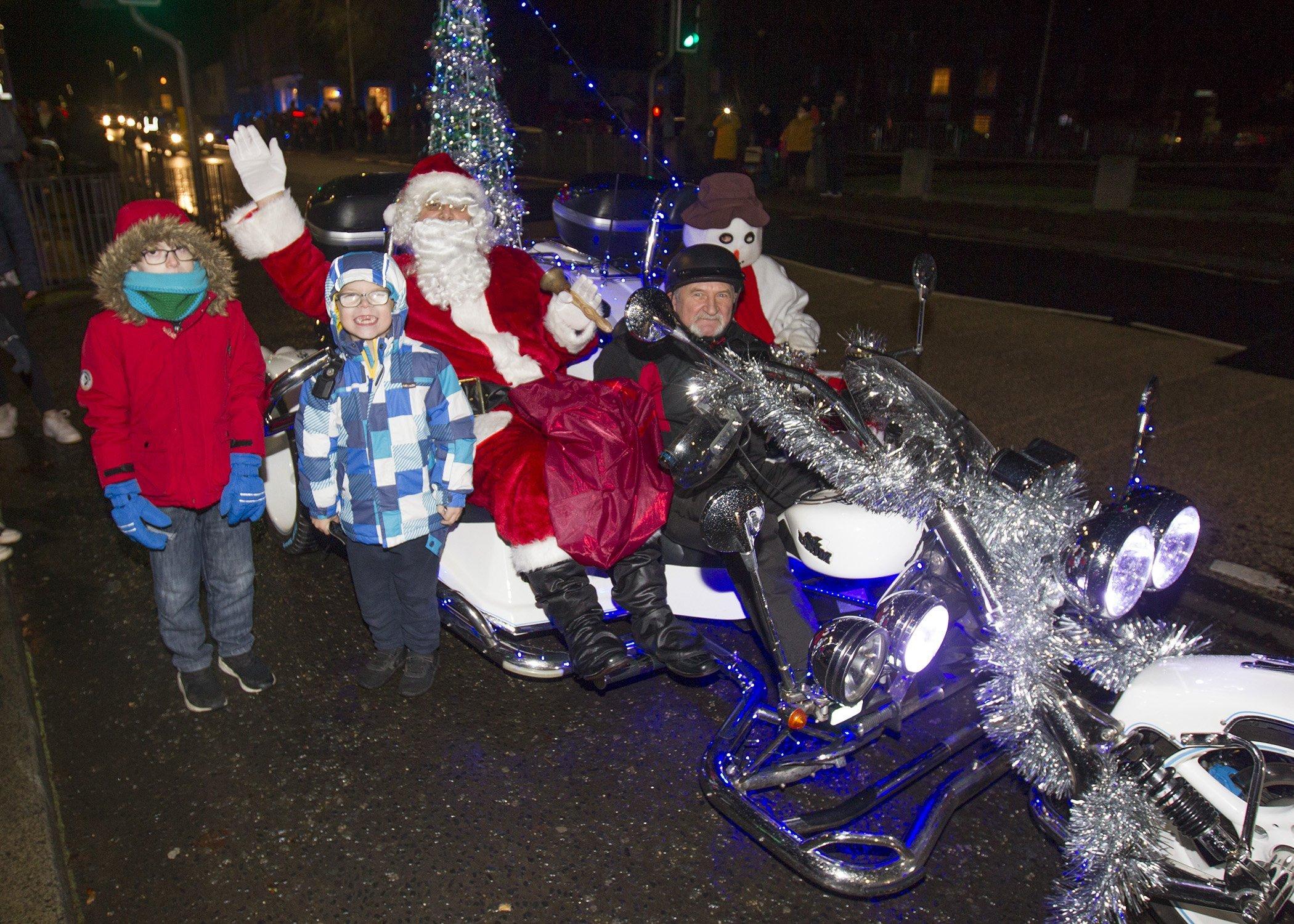 Leland and Caiden Sim from Hawick get to meet Santa as he arrives in style at Earlston