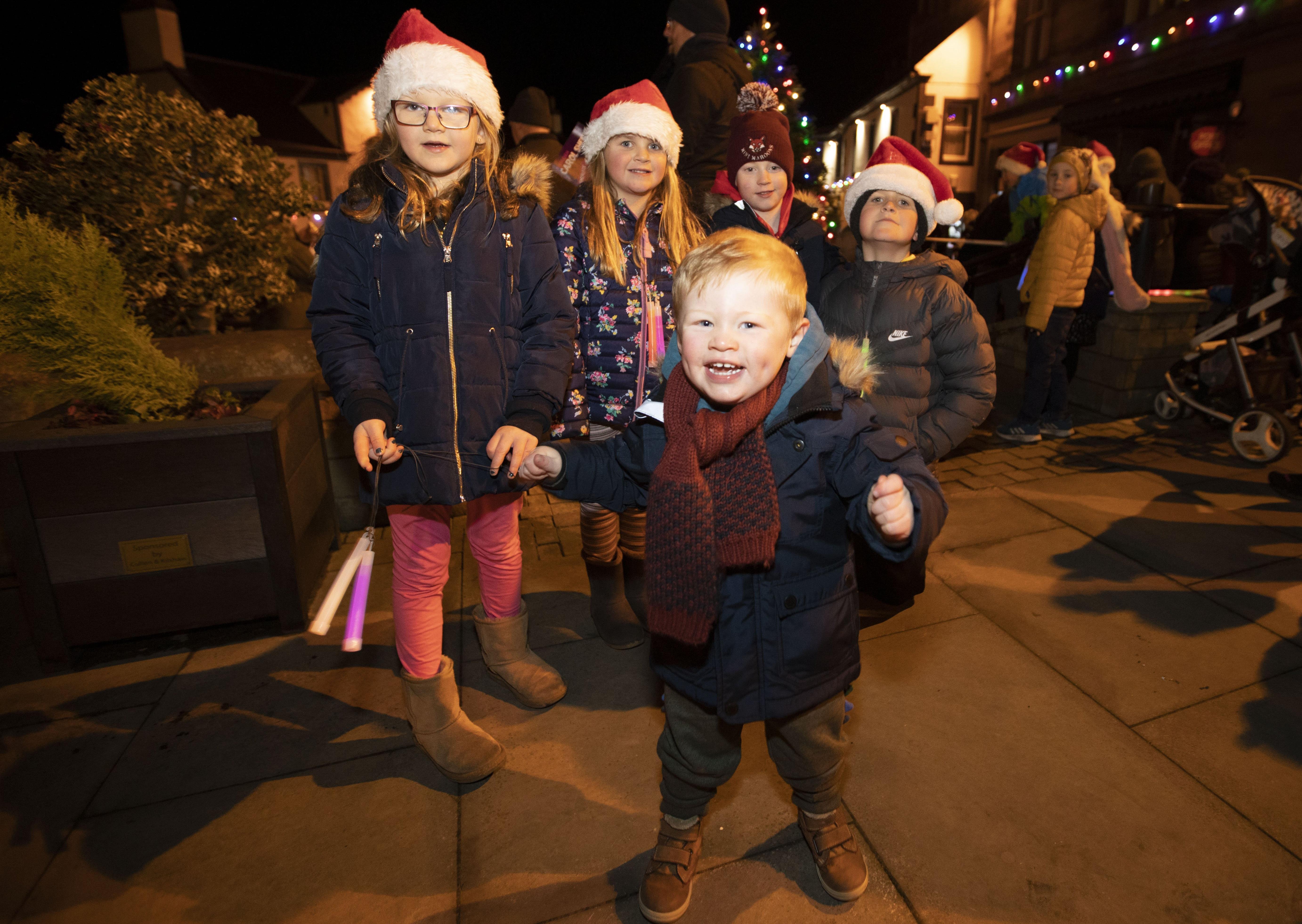 Children have a ball singing carols around the Christmas tree in Melrose.