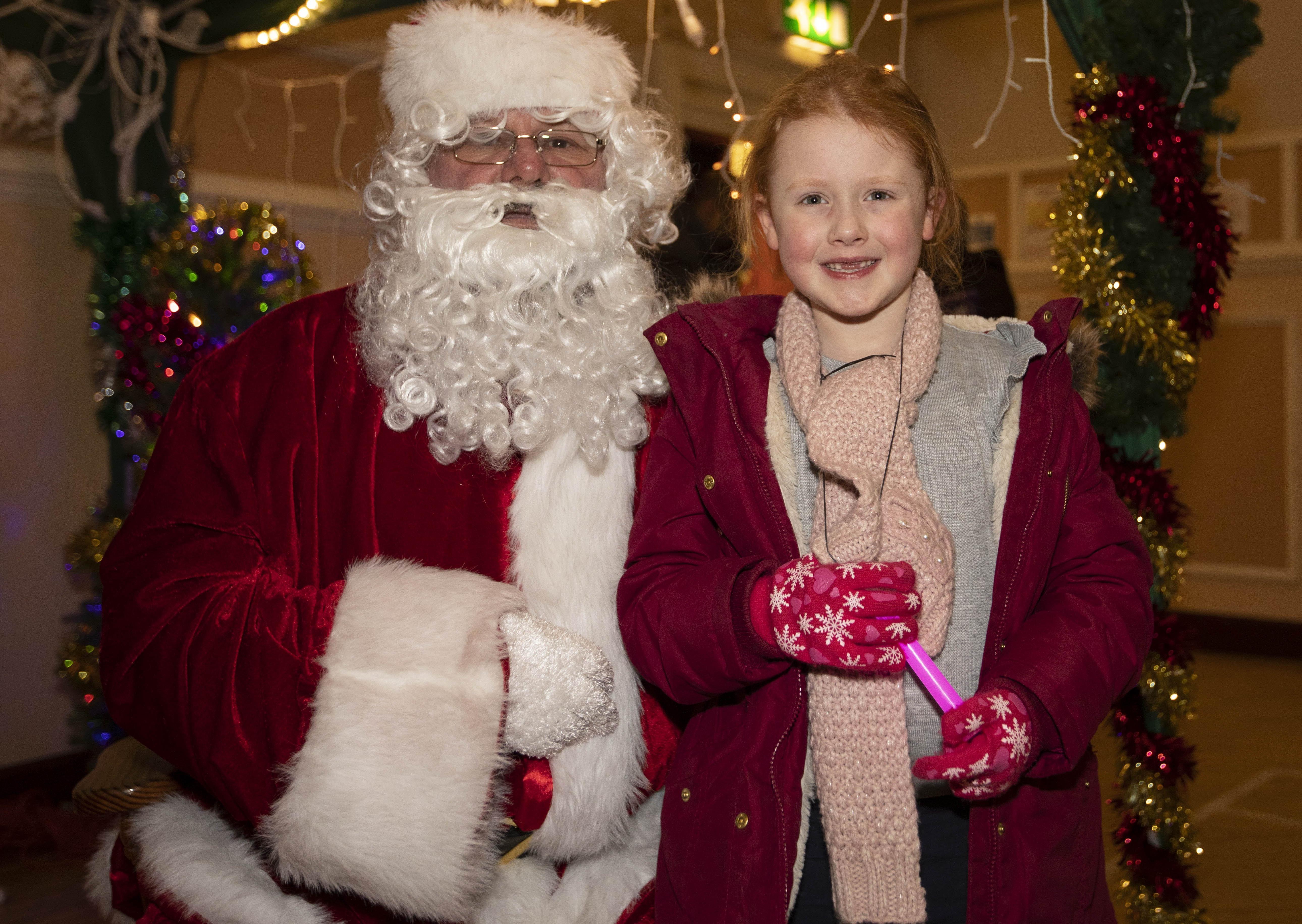 Grace McGrath is delighted to meet Santa in Melrose.
