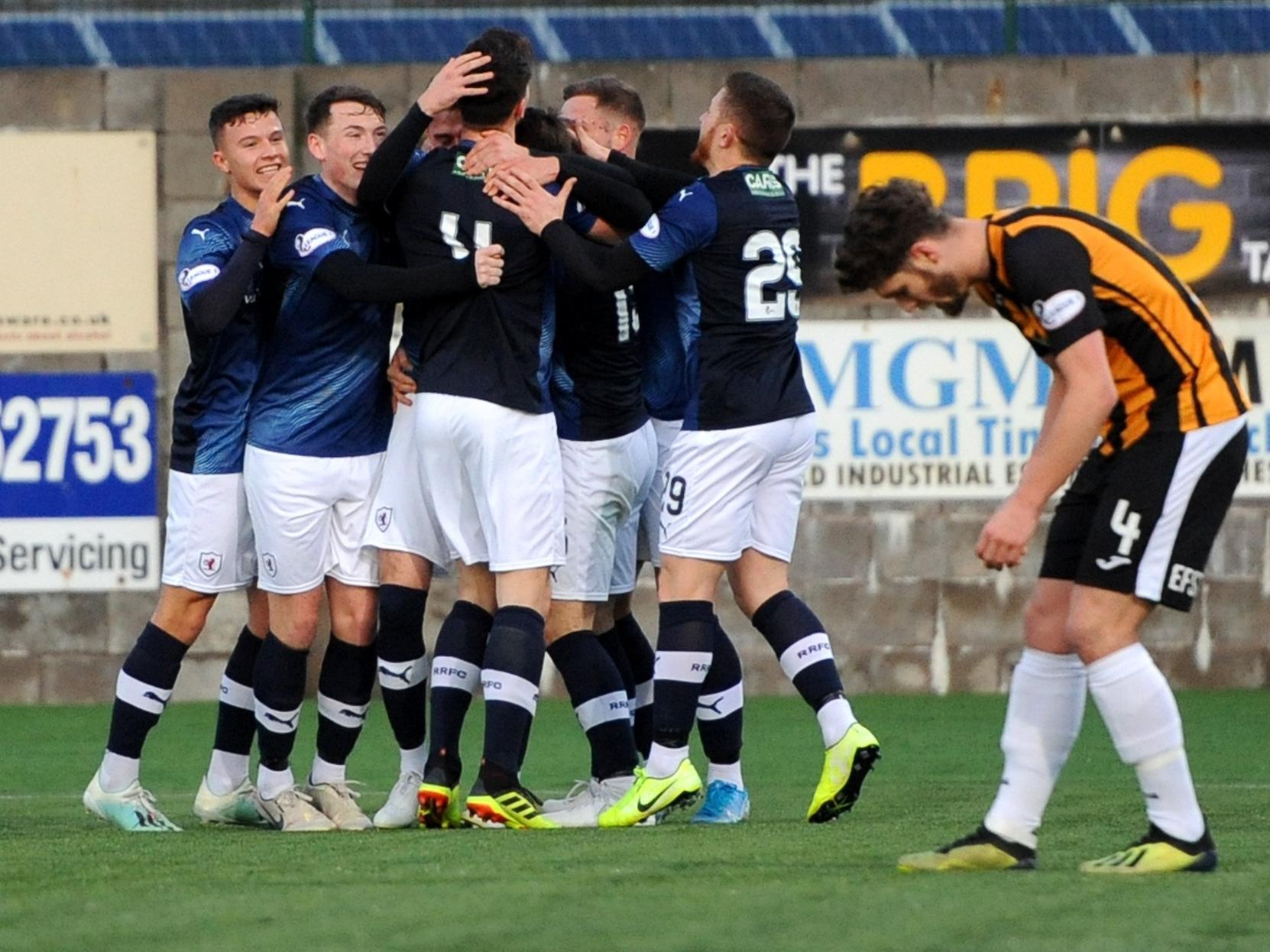 Raith players surround Kieran MacDonald after the left back fired Rovers into a 2-0 lead.