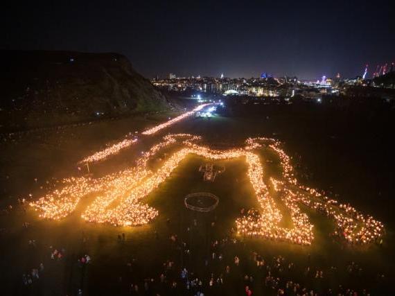 Torchbearers formed a message of togetherness and beamed it out during the spectacle in Edinburgh this evening. Pic: Edinburgh's Hogmanay Twitter.