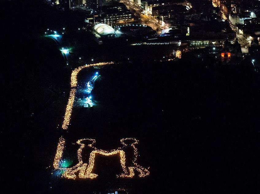 The scene in Holyrood Park was captured from a helicopter overhead creating an image to be shared with the world  a message of welcome and friendship from Scotland. Pic: Edinburgh's Hogmanay