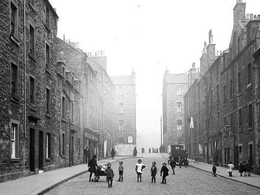 Children play in the streets, people browse in the shop windows and a bobby wanders down the Royal Mile on his beat. PLAYTIME: (Gifford Park, off South Clerk Street, before 1929)