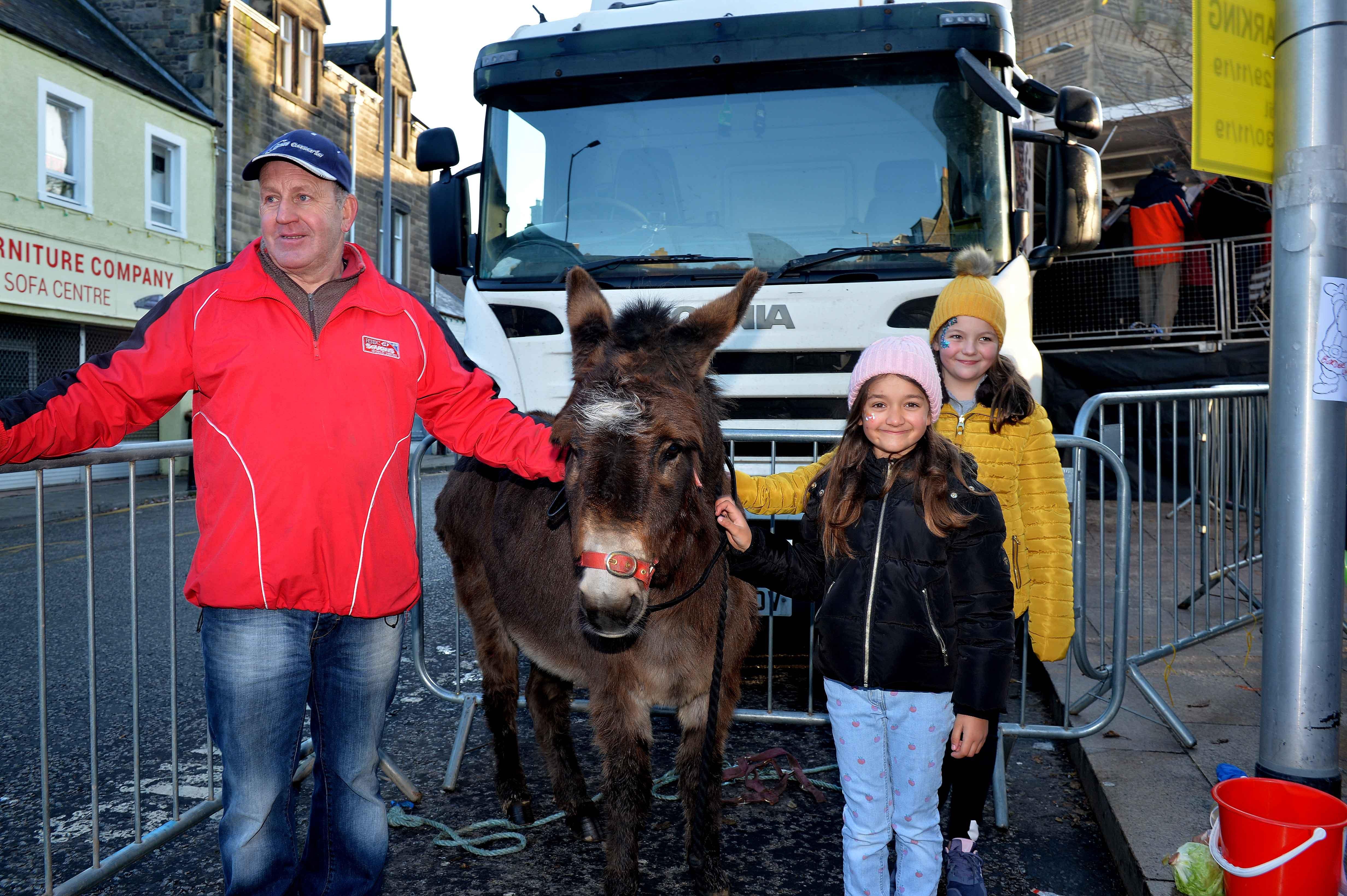 Peter Slattery ,Betty June the donkey,with Lexy Hume (10) and Aermje Todd (7)