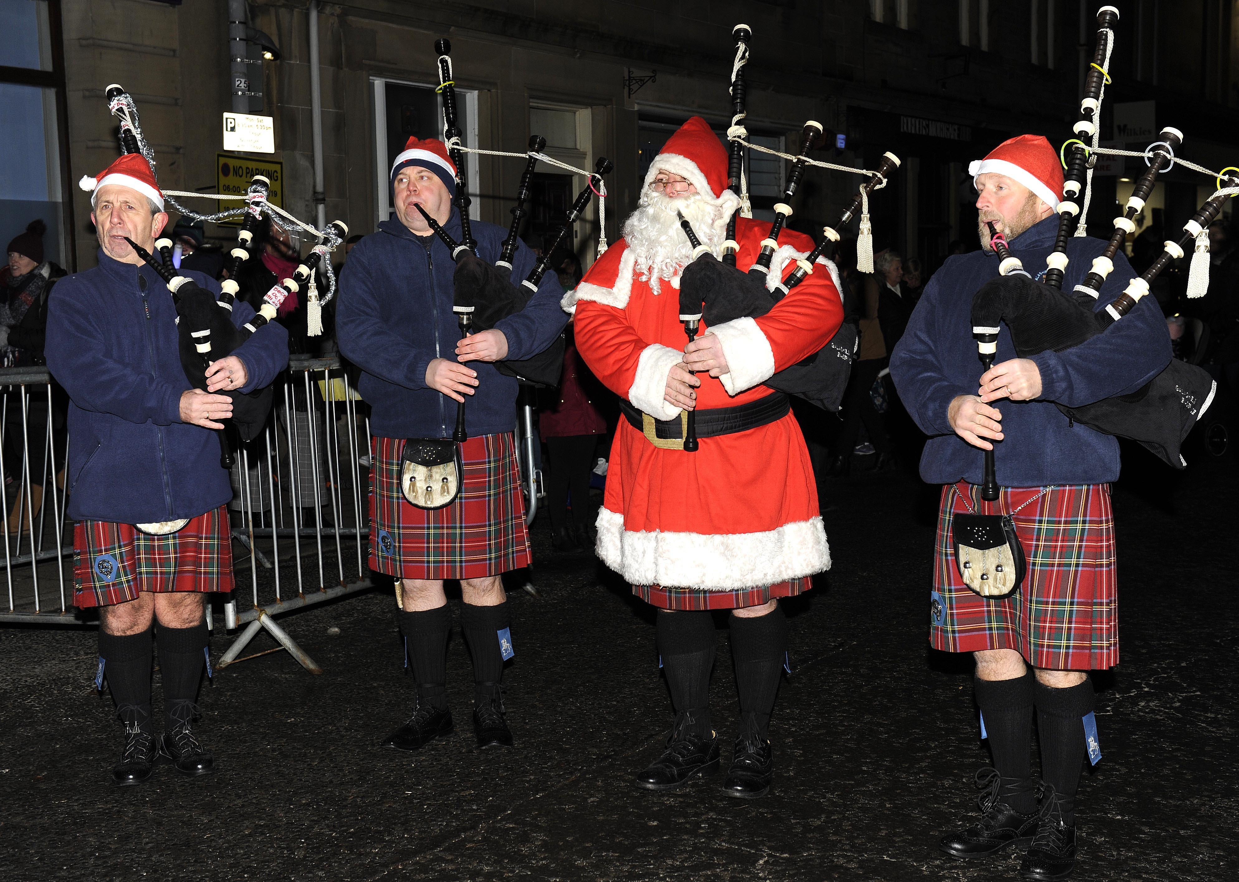 Santa helps out the pipe band.