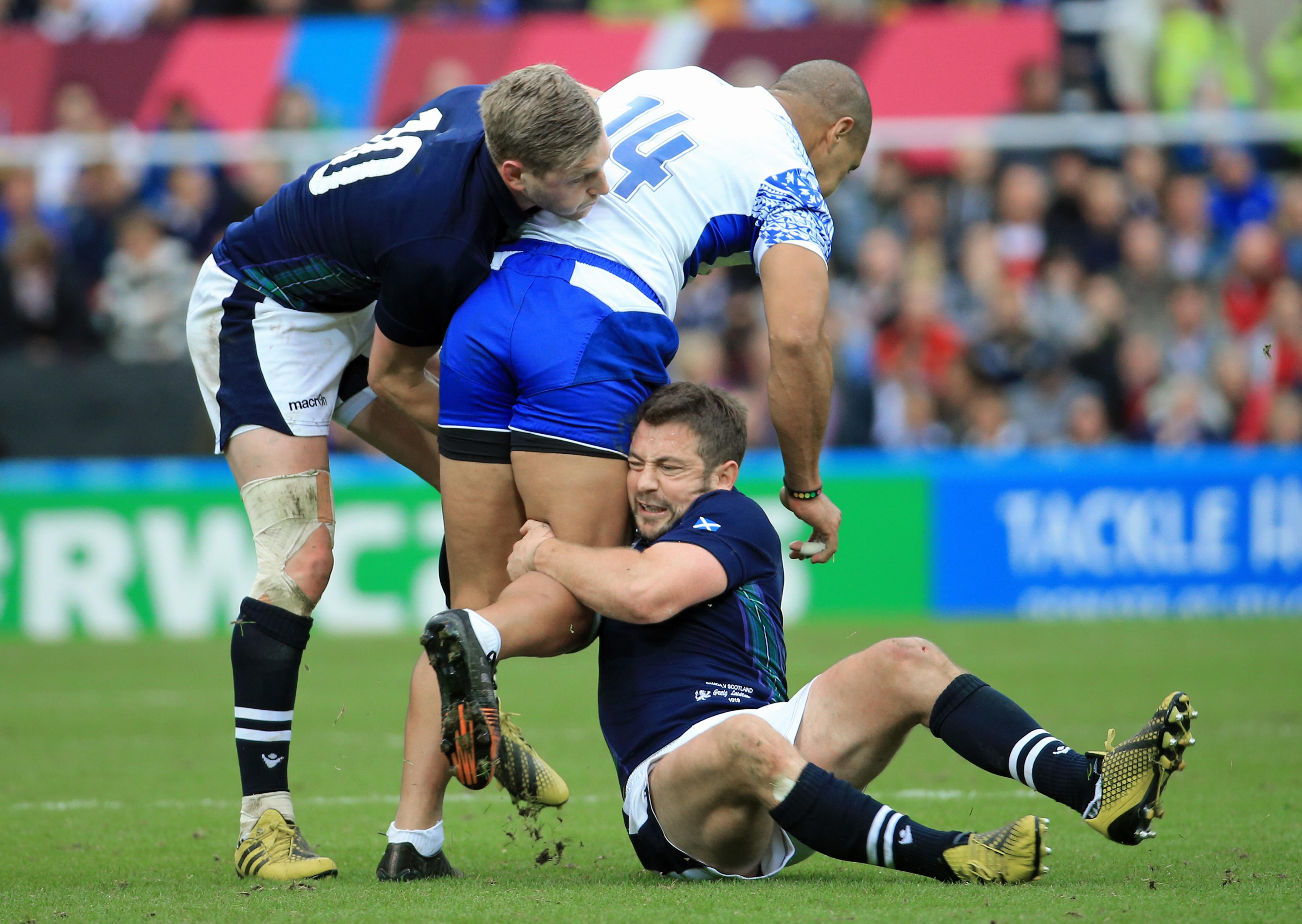 Greig Laidlaw and Finn Russell combine to stop Samoan winger Paul Perez in October 2015.