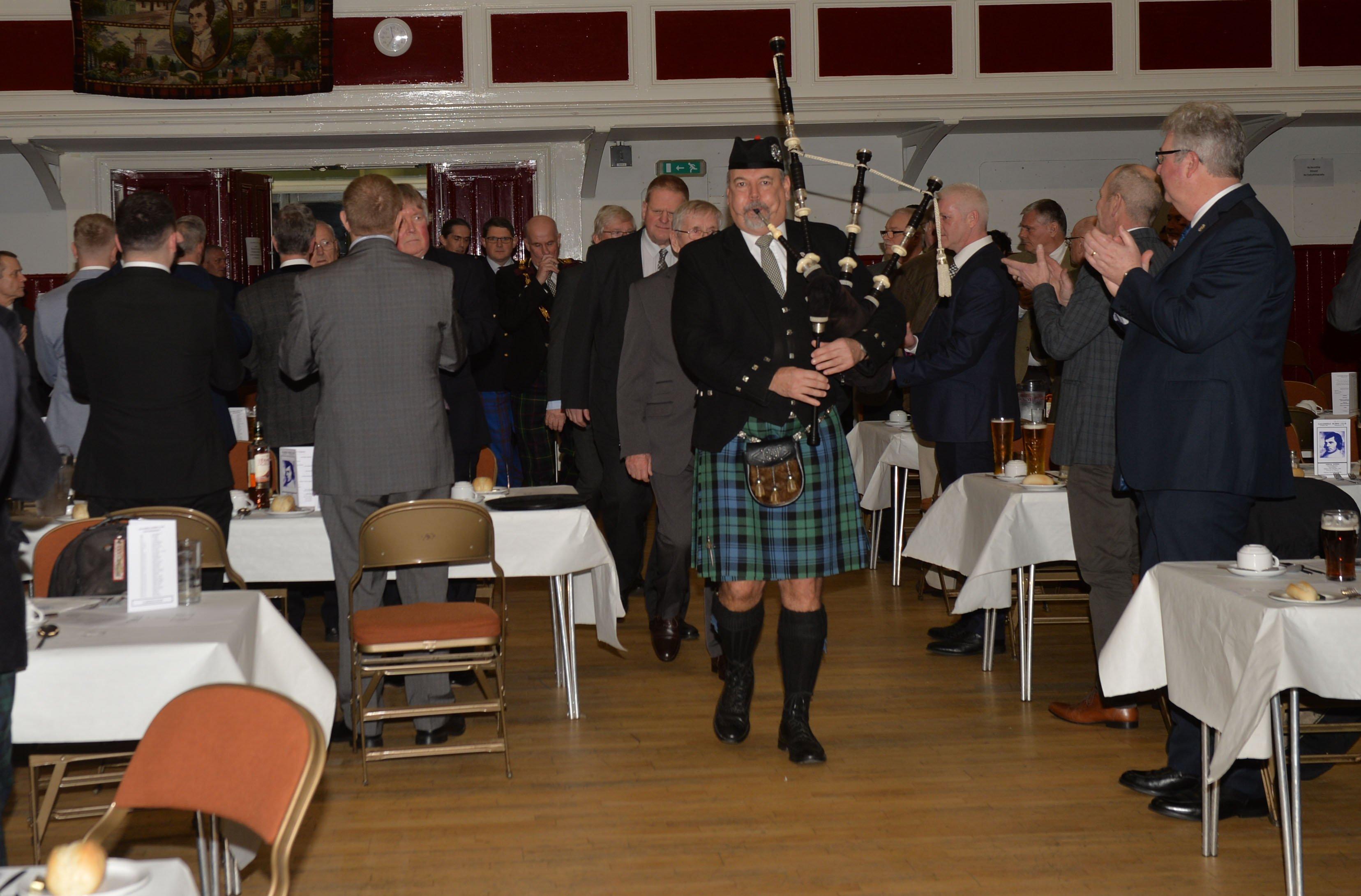 Piping in the top table, led by Bruce Hastie.