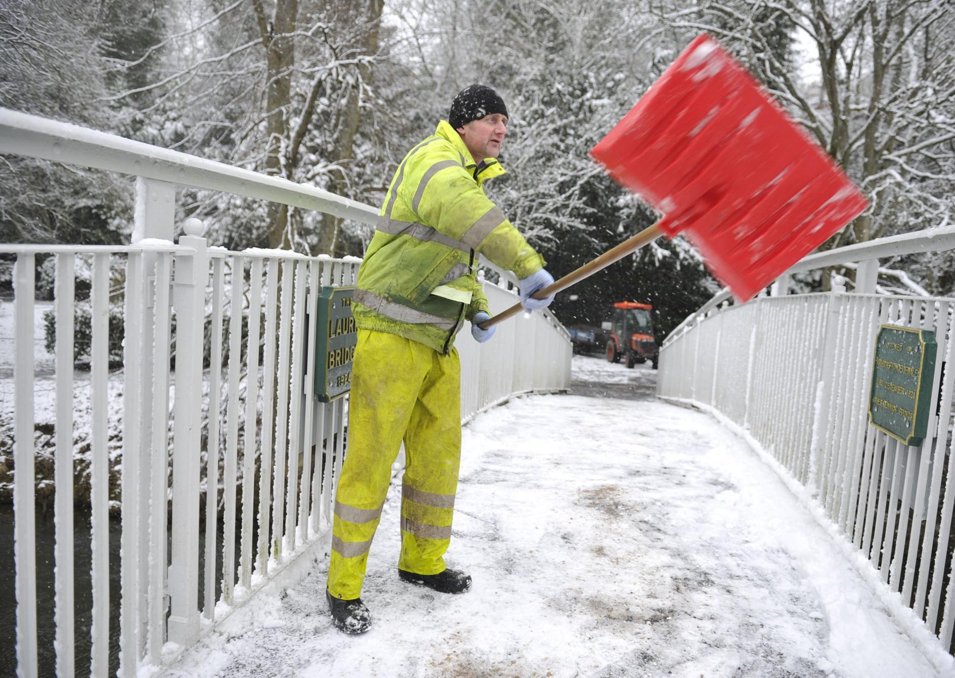 Park worker on The Laurie Bridge in Wilton Park Lodge, Hawick clearing the snow.