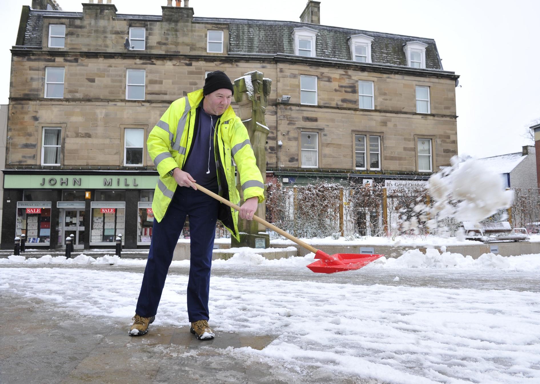 Snow being cleared in Market Square, Galashiels, Jan 2013.