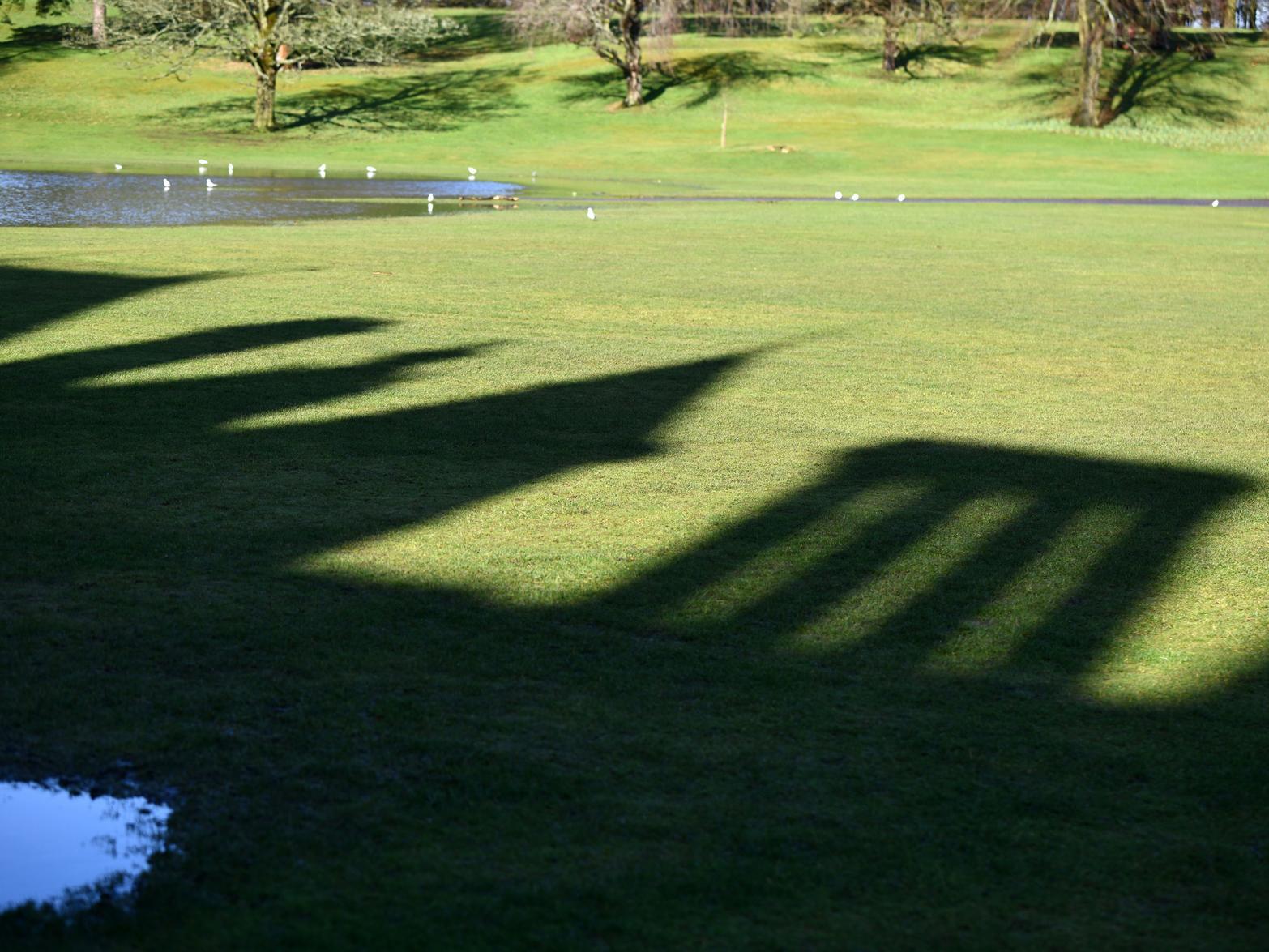 Shadow of Callendar House on the lawn.