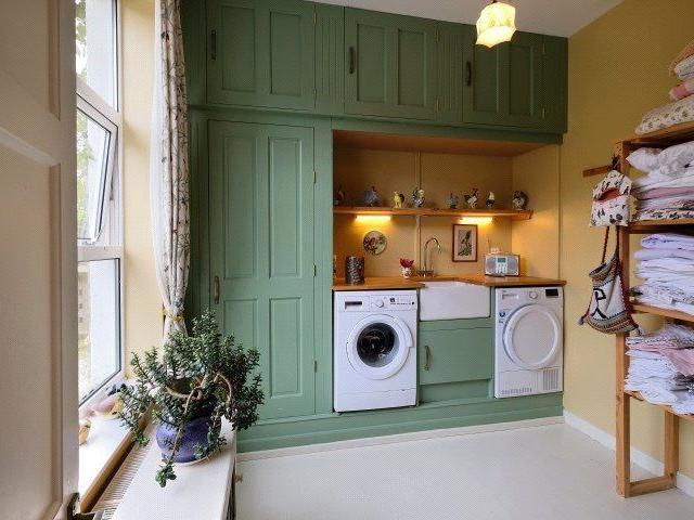 The property has a handy laundry room with space for a washing machine and tumbler dryer, a sink and shelves for linen.