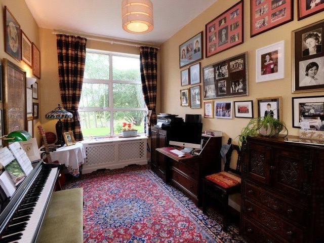 One of the reception rooms is being used as a music room/home office.