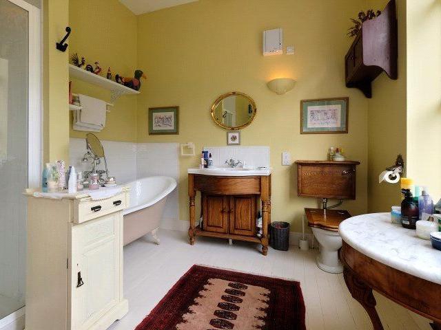 The main bathroom has a traditional style bath tub and separate shower.