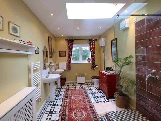 The second bathroom has a spacious shower and double sinks.