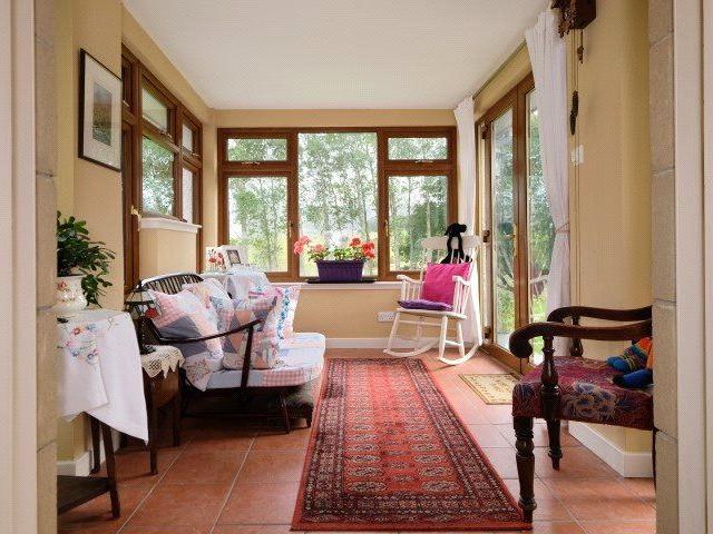 The sun room also has views over the garden and countryside and French doors out to the garden.