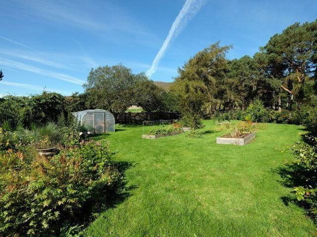 The garden extends to about 1.58 acres, comprising areas of lawn, well stocked beds and borders, and orchard and vegetable patches.