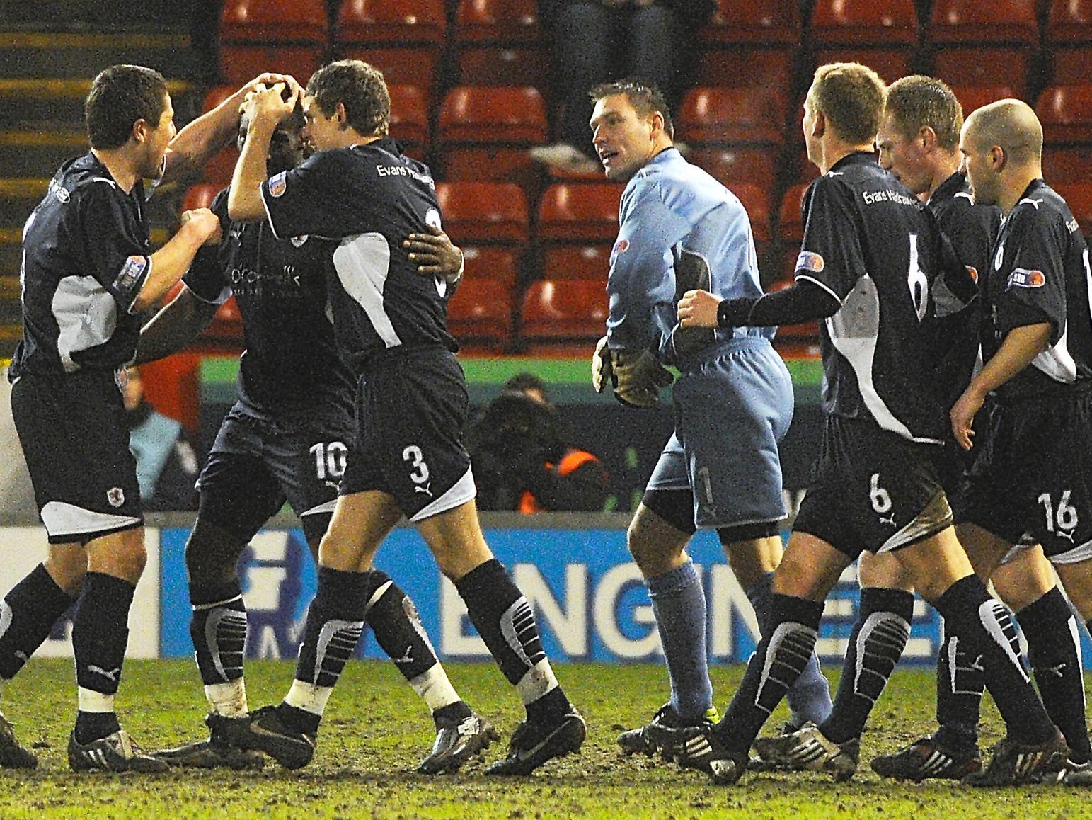 Raith players surround Gregory Tade after his goal.