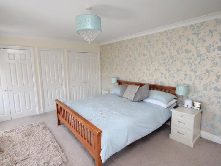 This is the property's master bedroom, complete with plenty of wardrobe space