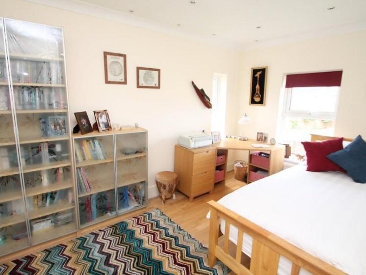 Plenty of storage space for reading materials in this attractive bedroom