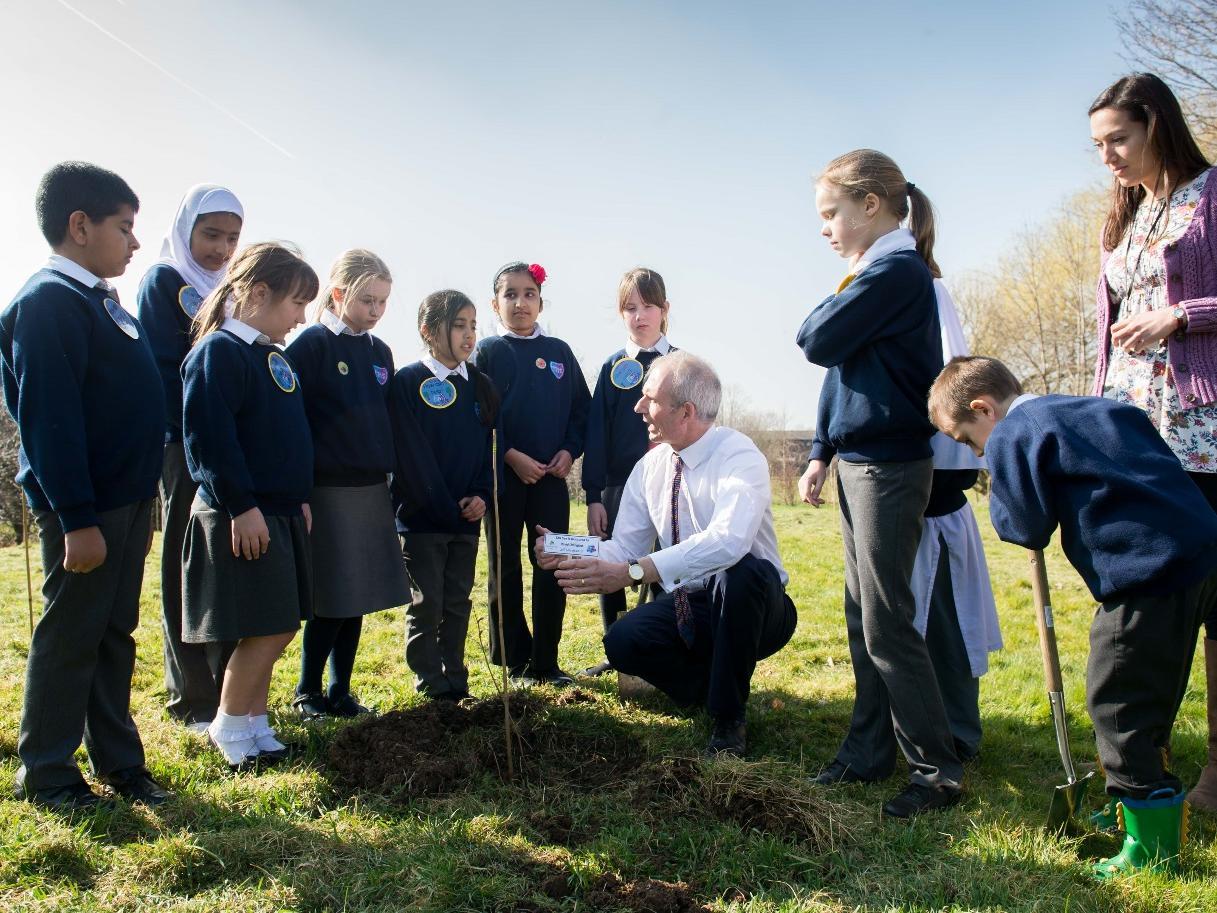 Planting trees with the Woodland Trust and youngsters from Thomas Hickman School in 2015