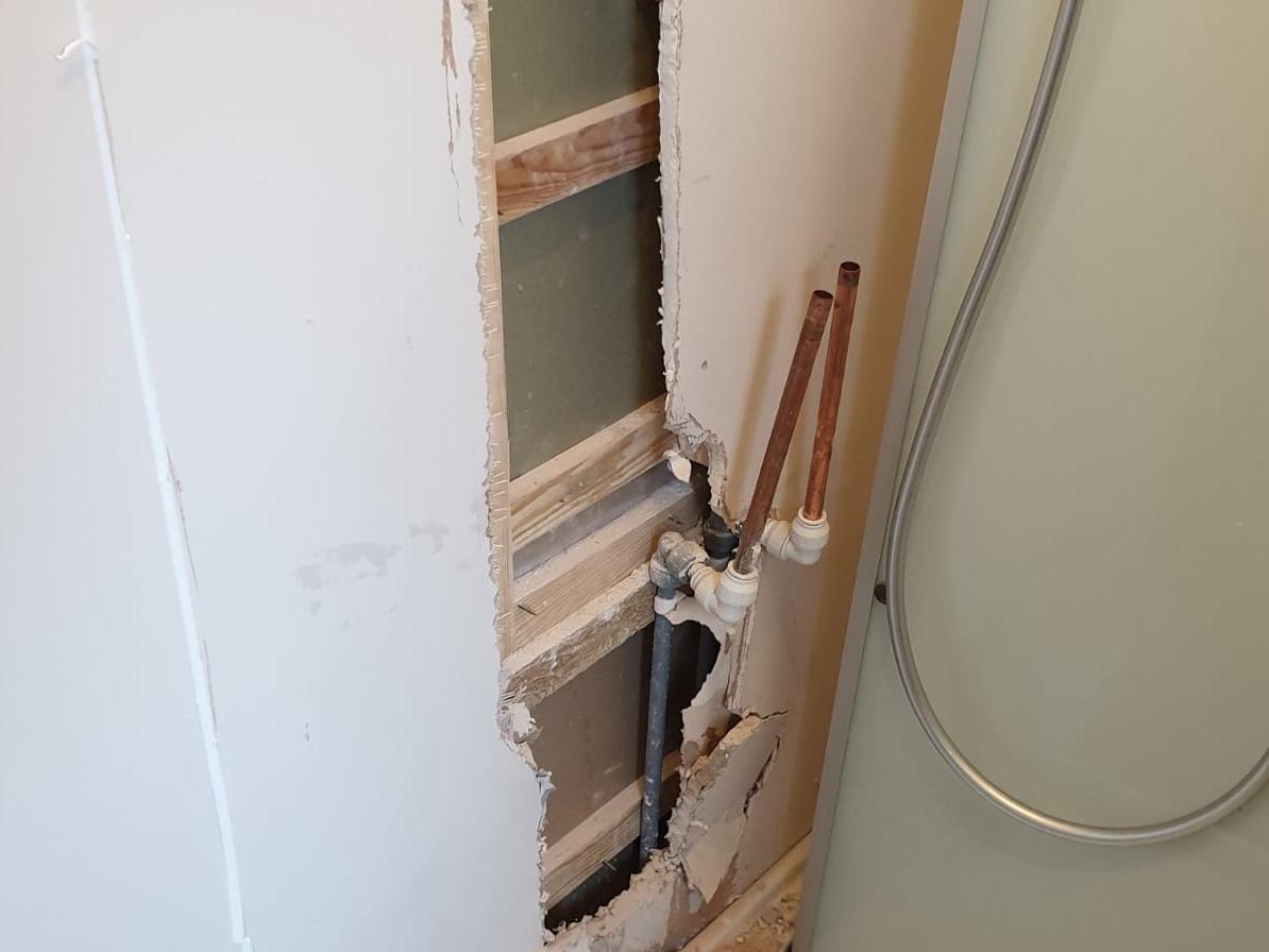 This is how a bathroom wall was left in Marc and Stacie Smith's home