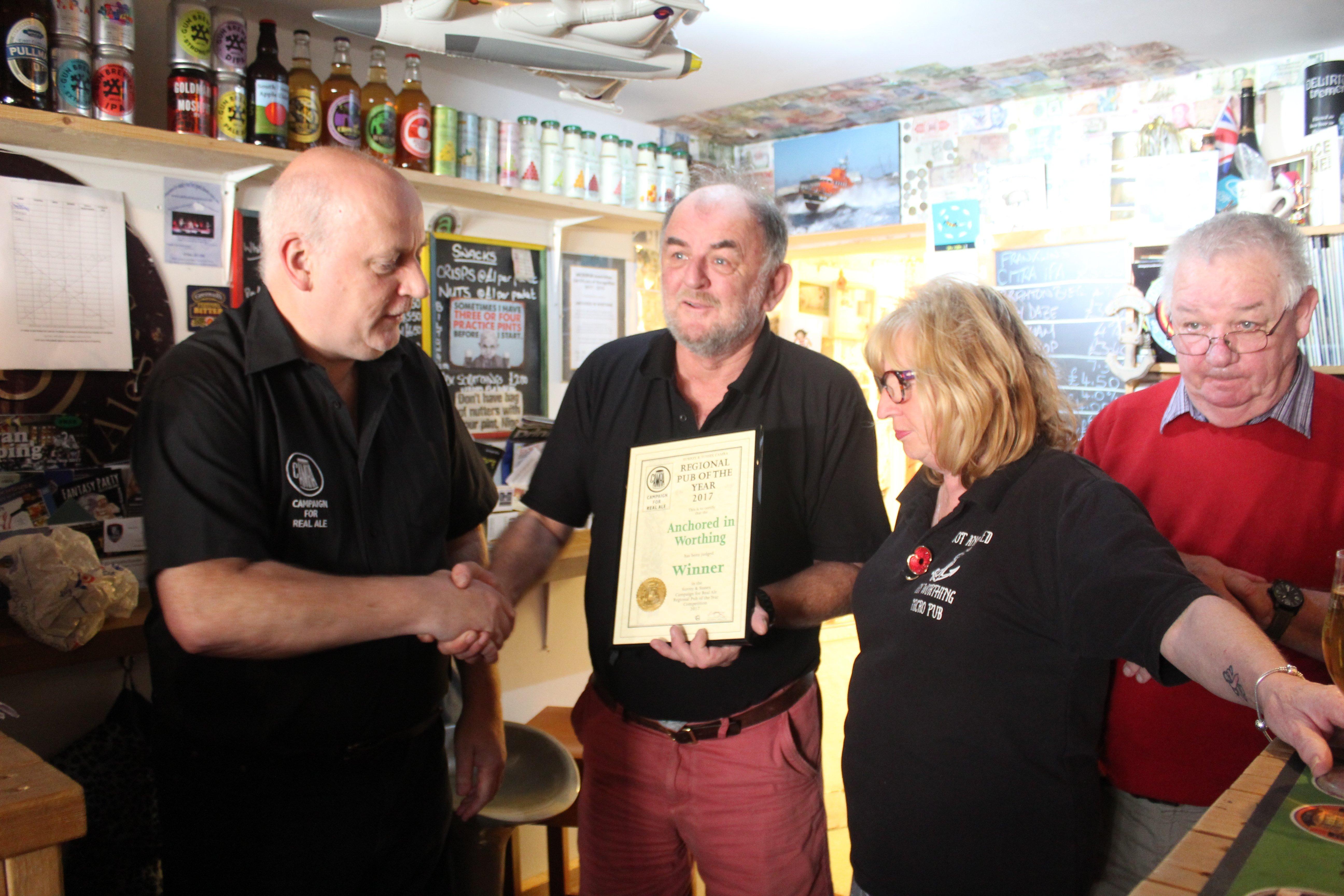Nigel Watson and Deborah Blakely, owners of Anchored in Worthing, receiving the Campaign for Real Ale's Regional Pub of the Year 2017 award from Chris Stringer. Picture contributed.