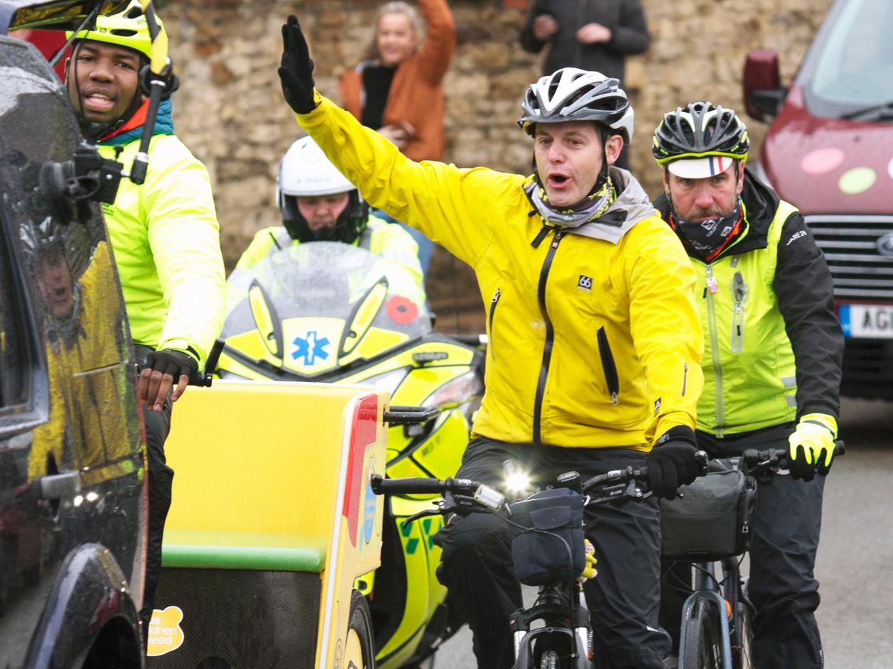 Matt Baker gives a wave to crowds in Weekley. People have been tracking the Rickshaw's route and going to support the team.