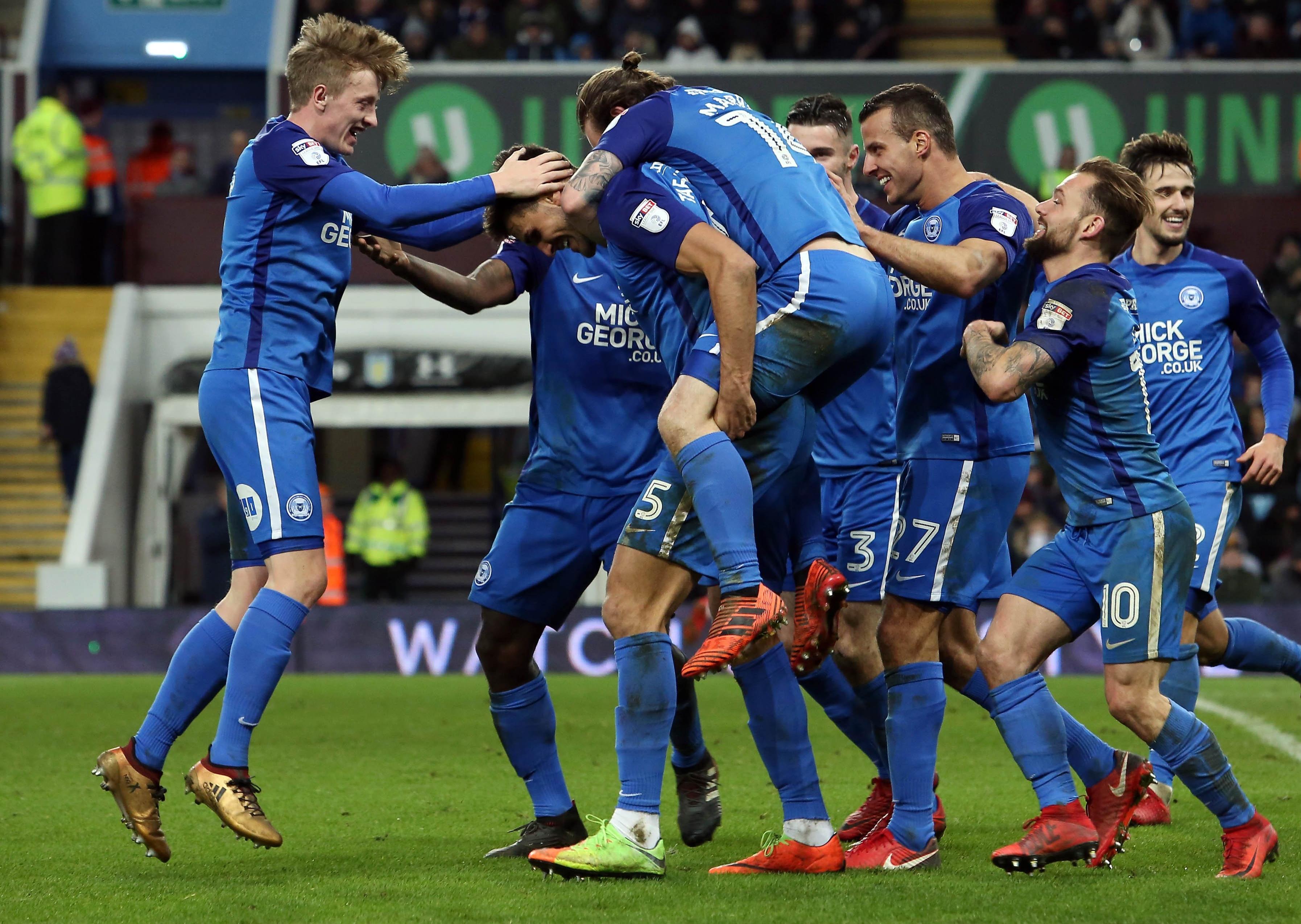 Posh players celebrate a goal against Aston Villa in 2018.