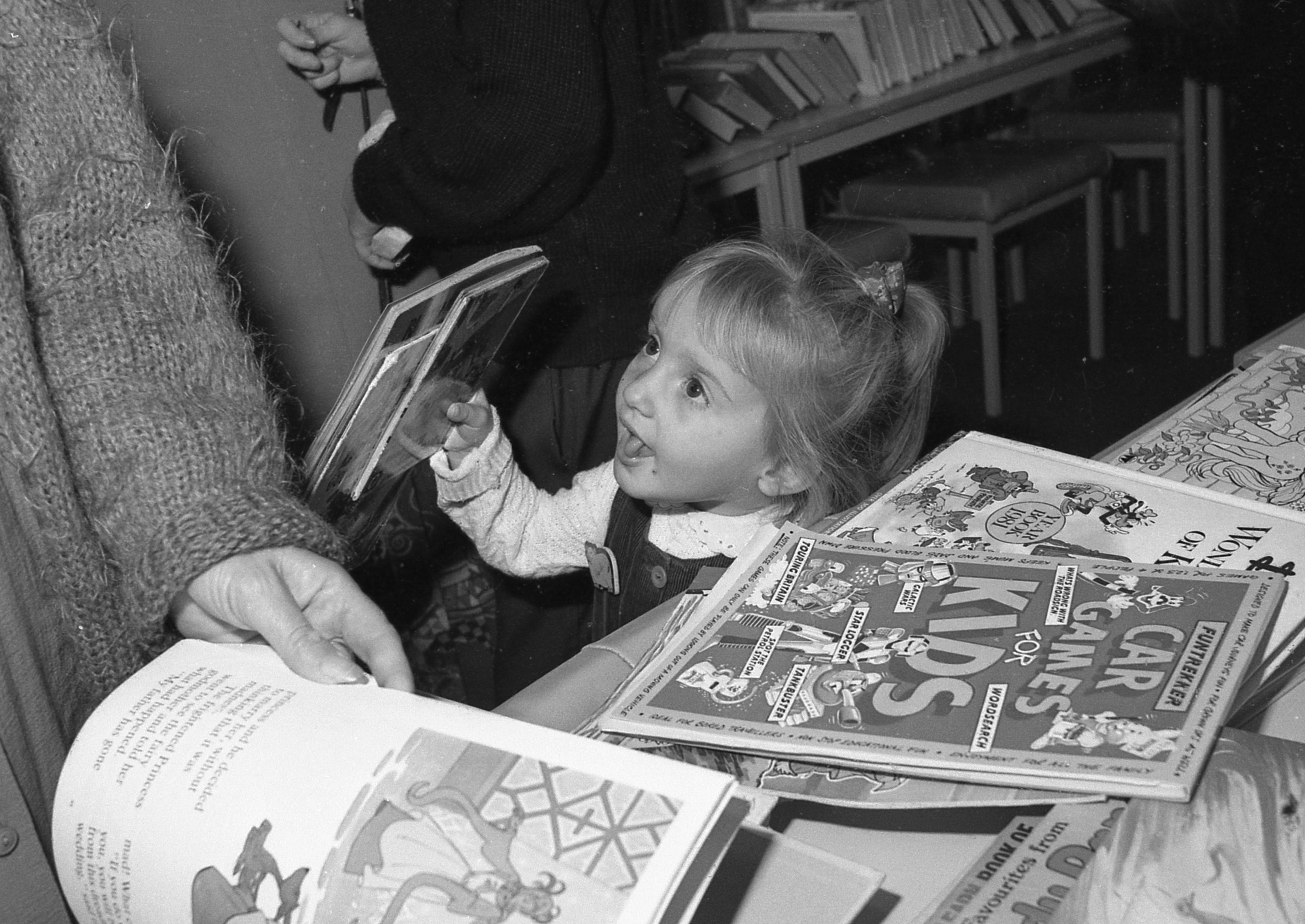 Little Heidi Wharff finds a bargain among the books.
