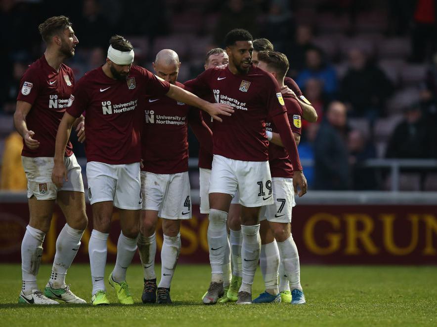 The Cobblers players celebrate Vadaine Oliver's goal