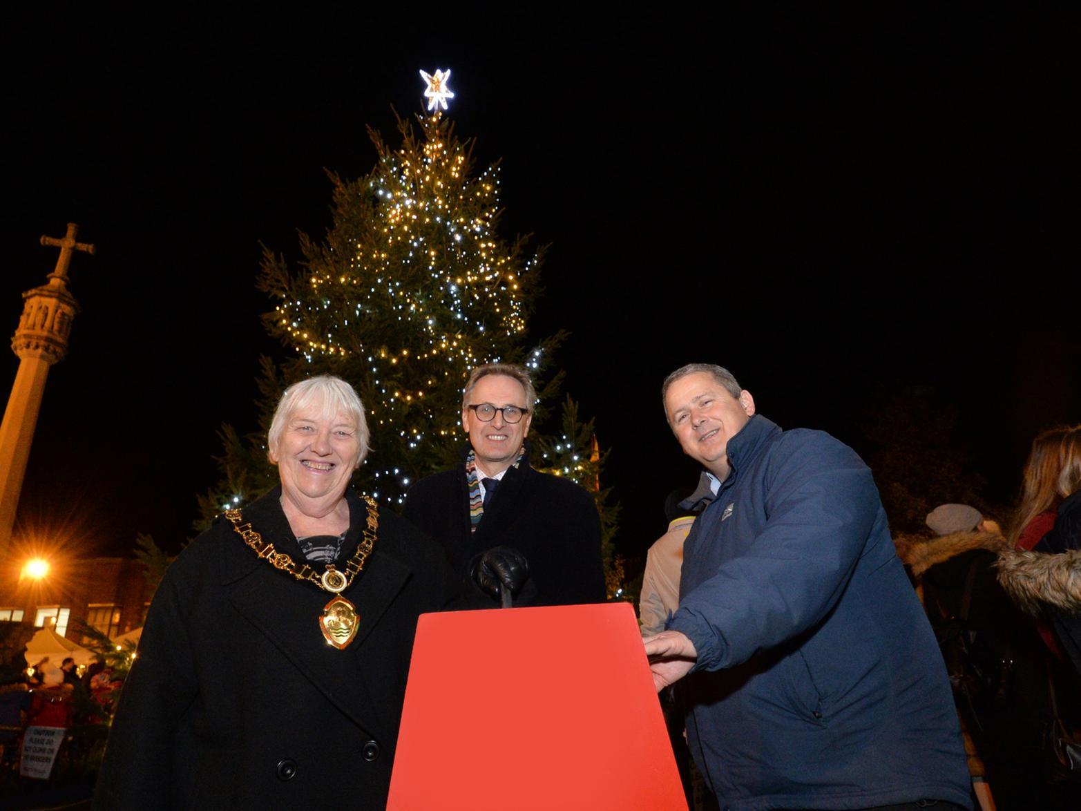 Chairman of Harborough District Council Barbara Johnson, Mark Robinson chief executive of Market Harborough Building Society and leader Phil King switch on the Christmas Tree lights on the Square.