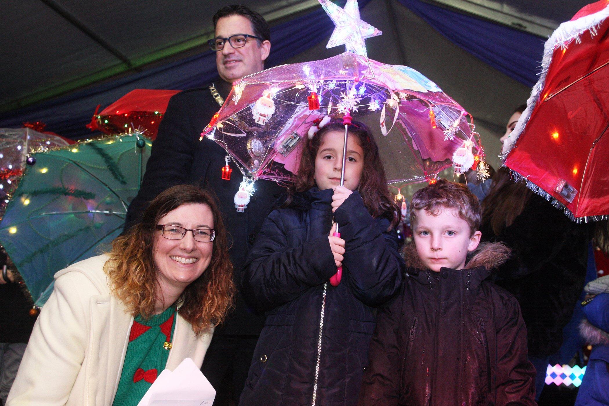 DM19112424a.jpg. Haywards Heath Christmas Lights. Illuminated umbrella competition runner-up Kasia Dighton with Gina Stainer from the Mid Sussex Times. Photo by Derek Martin Photography. SUS-191123-215702008