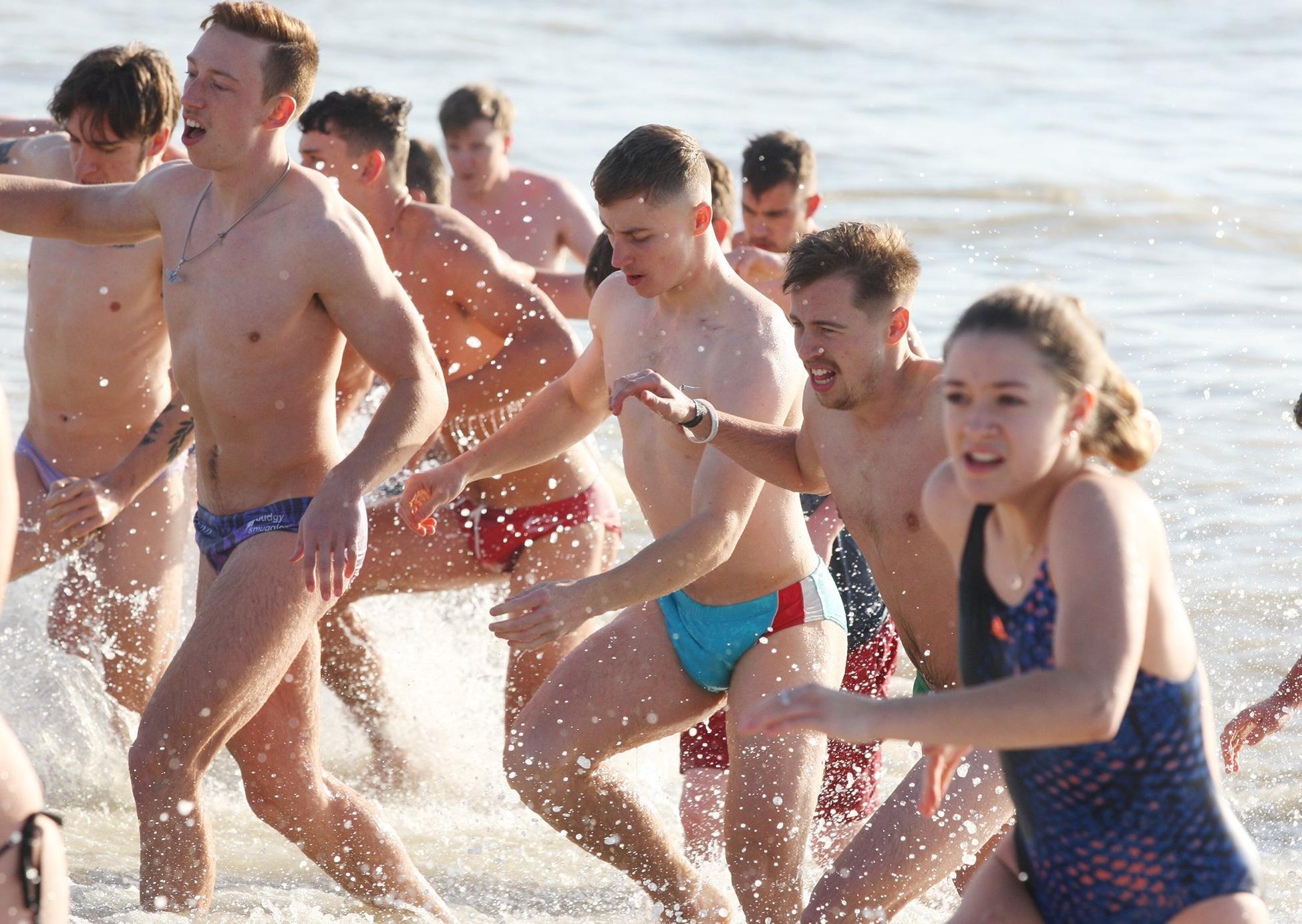 DM19112498a.jpg. Chichester University students take a dip in the sea for Movember. Photo by Derek Martin Photography. SUS-191124-162456008