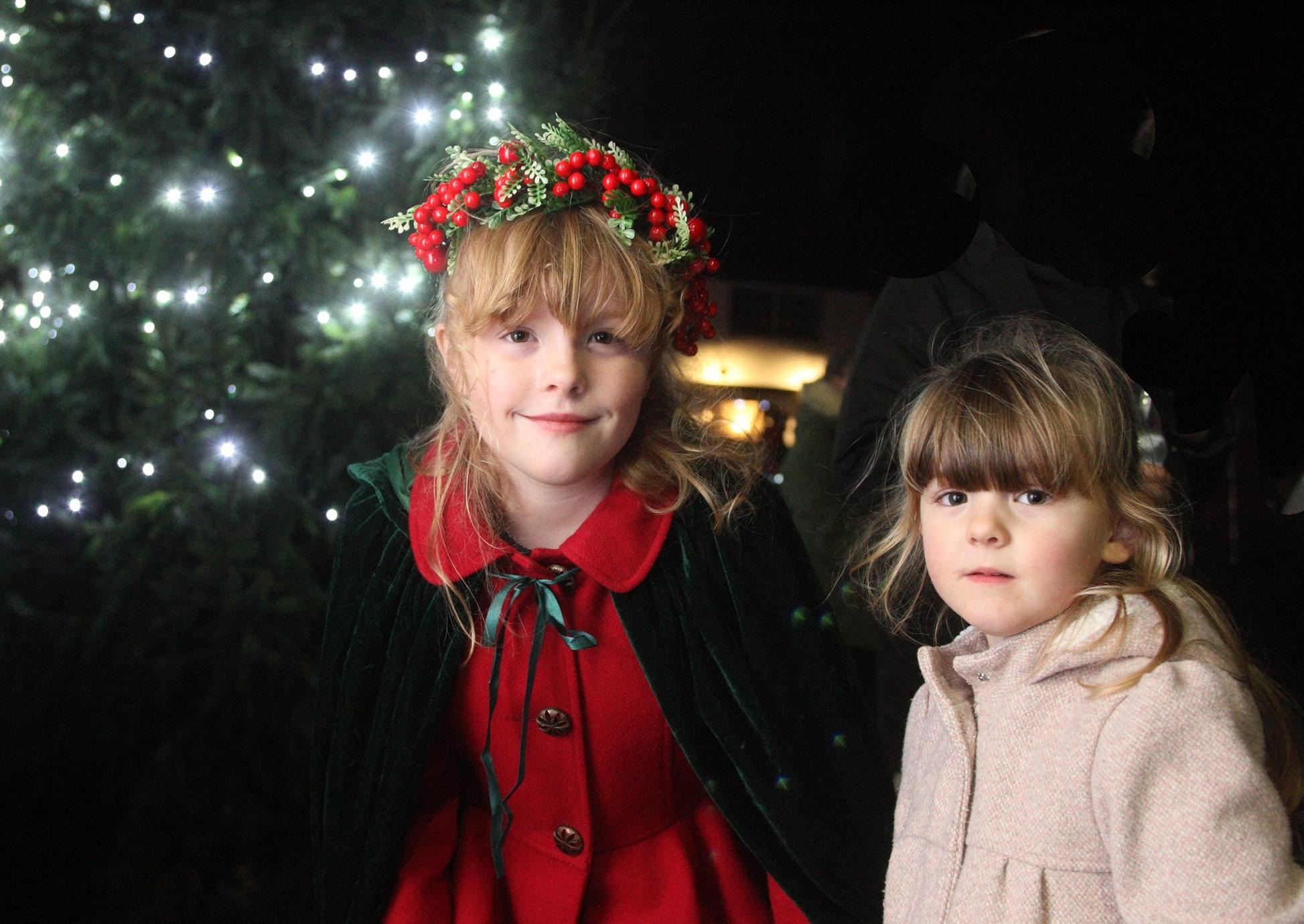 DM19121196a.jpg. Midhurst Christmas street party, 2019. Molly Shadbolt, 9, turned on the Christmas tree lights. Pictured with her sister Ruby, 3. Photo by Derek Martin Photography. SUS-190612-214133008