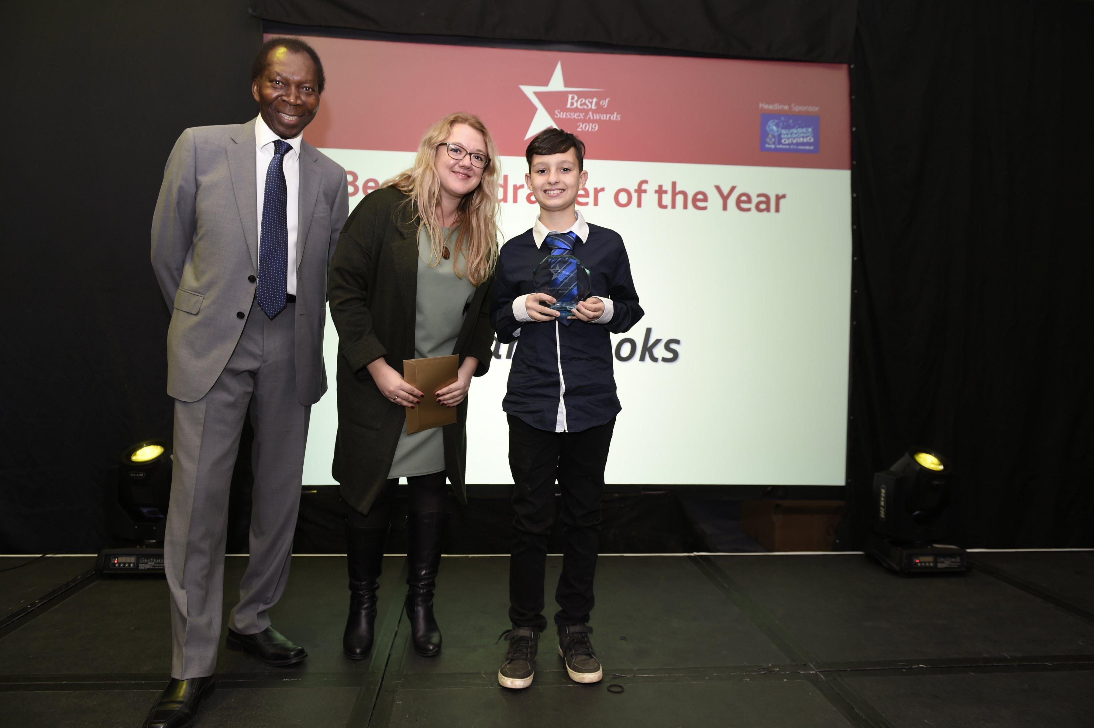 Dan Brooks (12) receiving the Fundraiser of the year award with Bex Bastable (JPIMedia) and Ambrose Hartcourt.   Picture: Liz Pearce.   LP192049