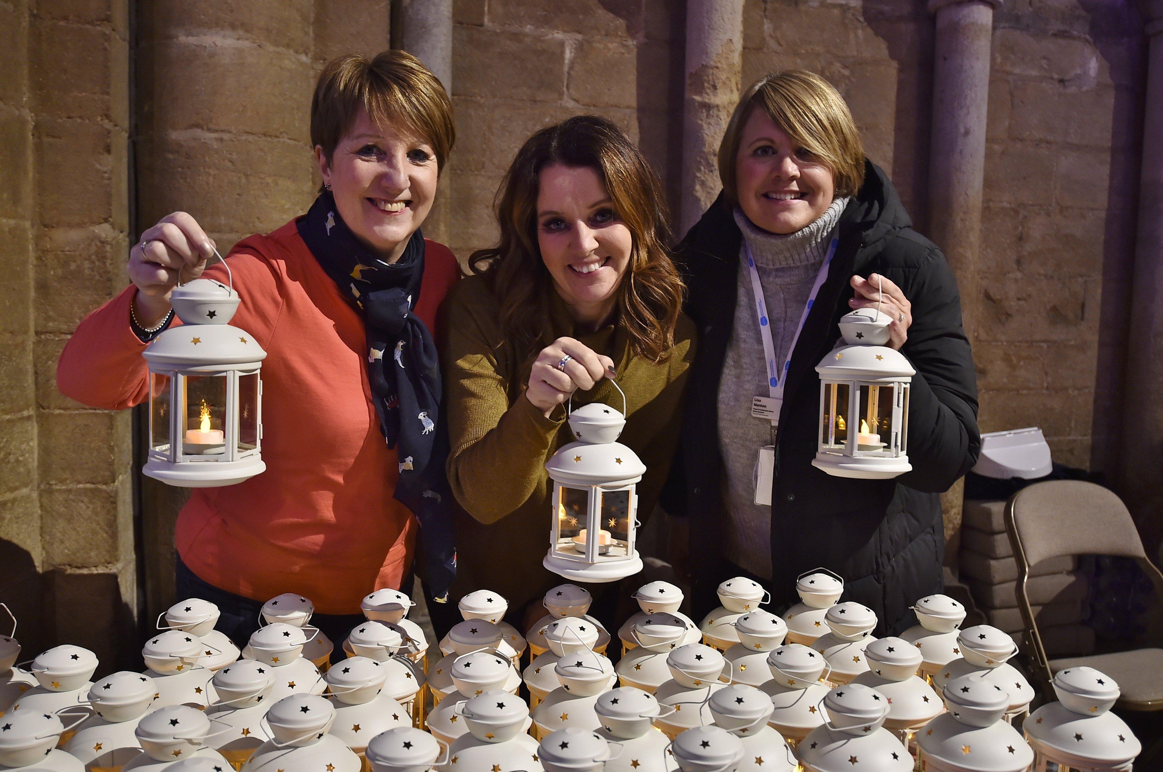 Sue Ryder Lights of Love service at Peterborough Cathedral.  Judy Gregory, Kerry Ash and Lisa Manton with lanterns. EMN-191215-215636009