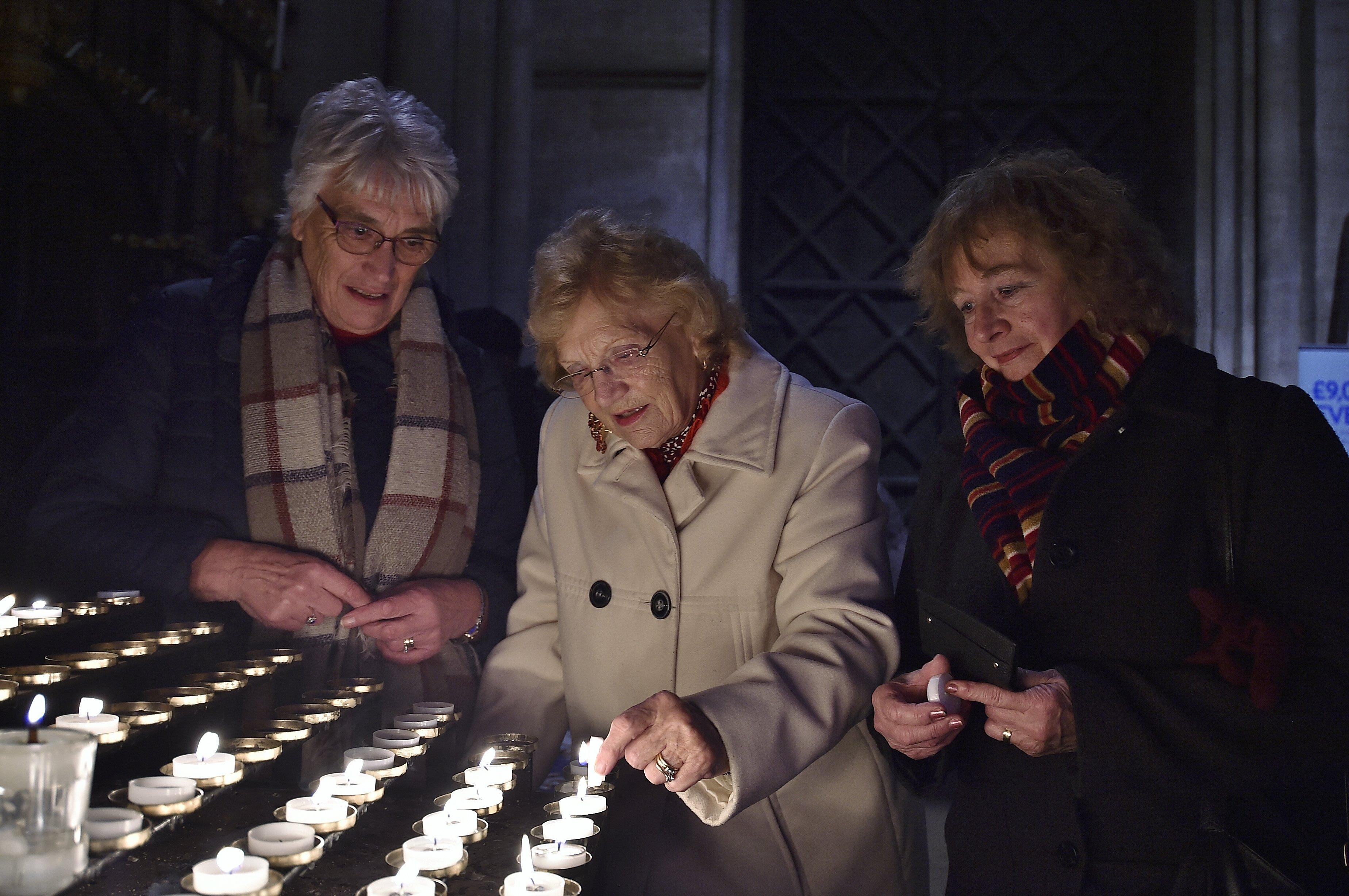 Sue Ryder Lights of Love service at Peterborough Cathedral.    Jennifer Peck, Helen Anton and Jackie Mills lighting candles. EMN-191215-215705009