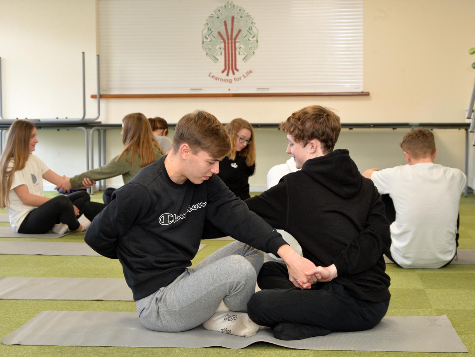 Students learn yoga.