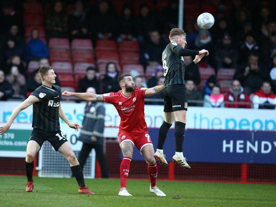 Scott Wharton and Ryan Watson challenge for the ball with Crawley's Ollie Palmer. Pictures: Pete Norton