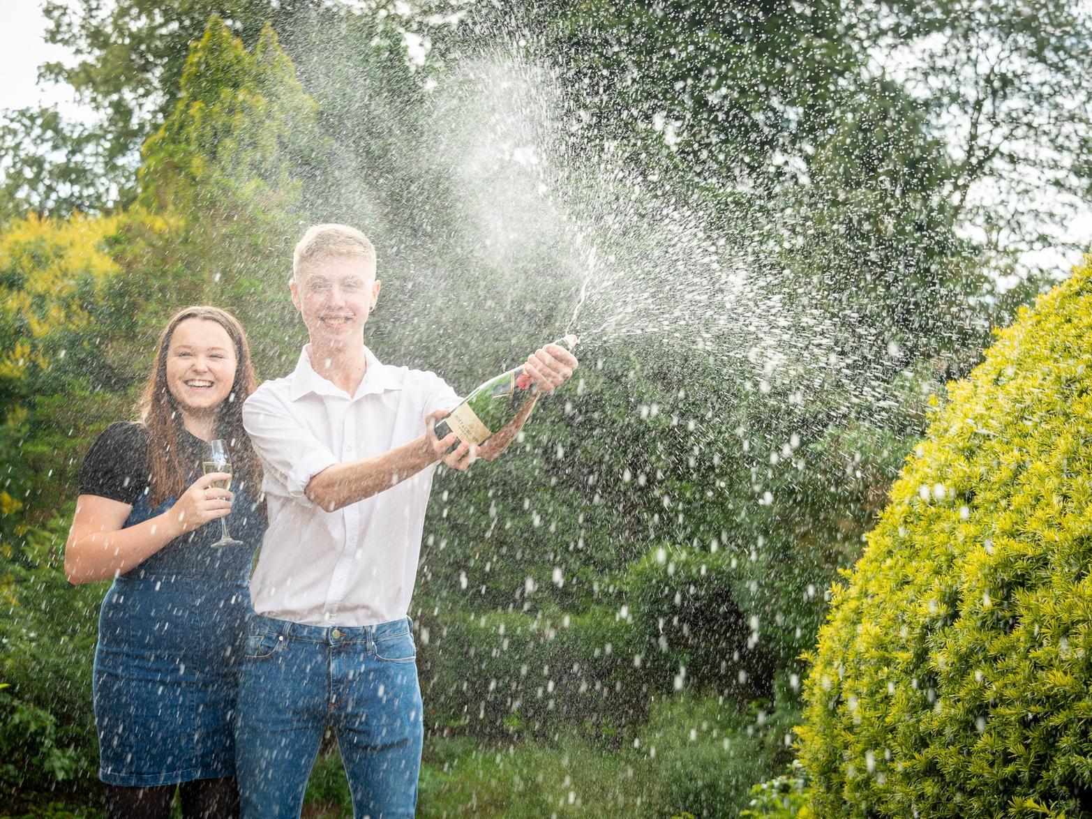 Lottery winner Sam Lawton from Leamington won 120,000 in August after buying his first ever ticket!
He is pictured spraying the Champagne with his partner Connie Bell. 
The former Campion School pupil Sam, 19, was a winner of the 10,000 a month for 12 months 'Set For Life' draw and said the 120,000 prize has come at the "best possible time" for him and his young family.