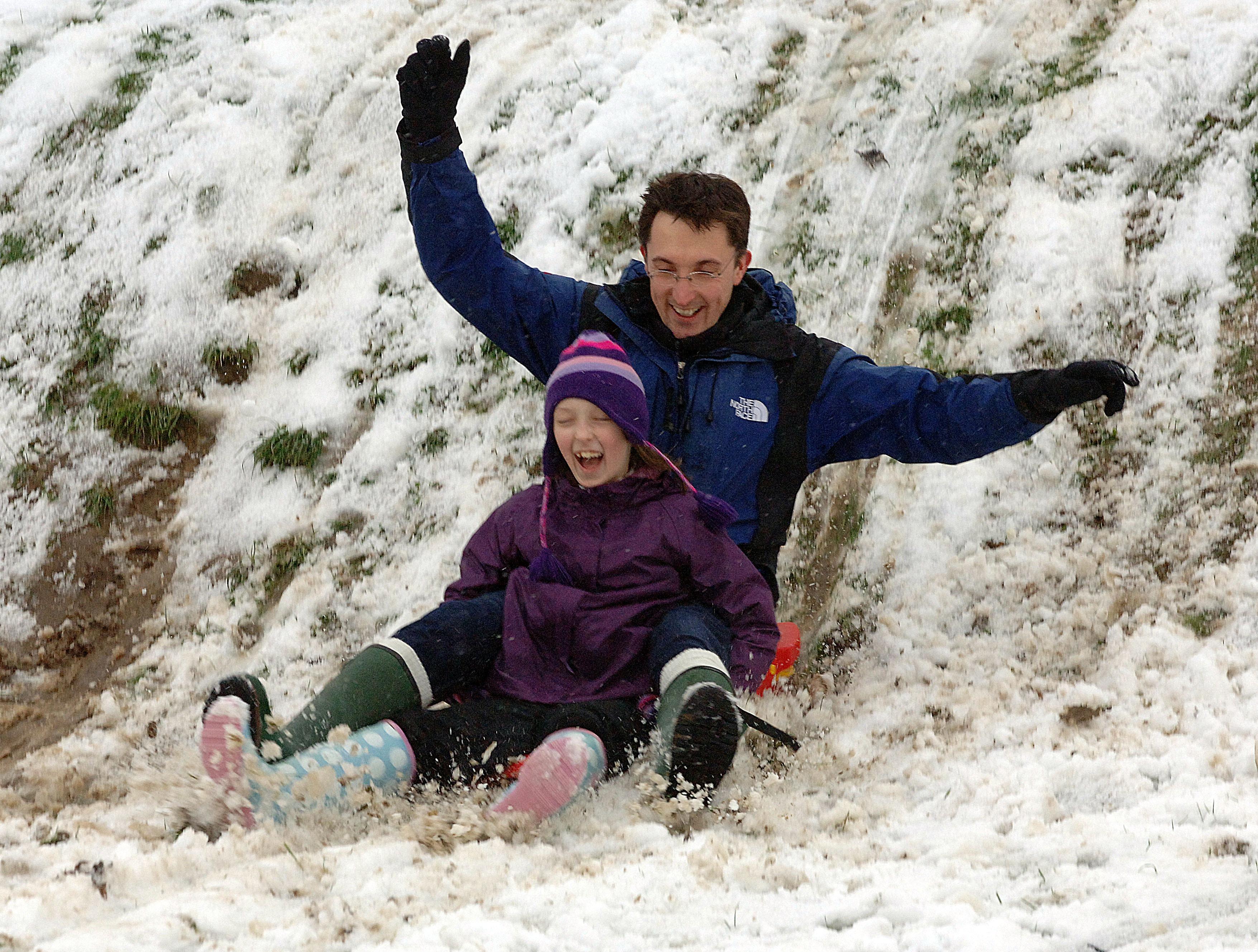 Fun in the snow for these two sledgers. Photo: Malcolm McCluskey