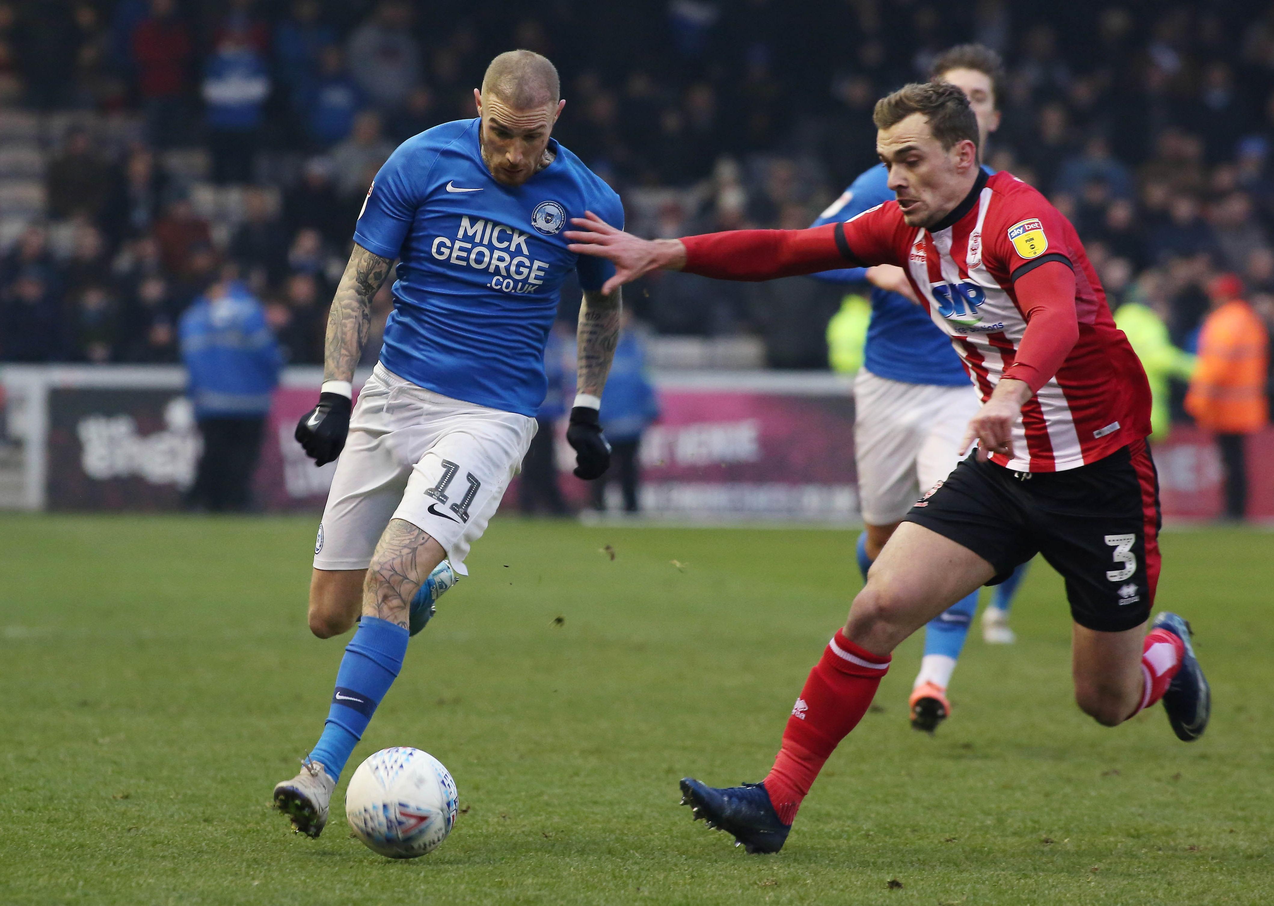 Marcus Maddison of Peterborough United in action with Harry Toffolo of Lincoln City. Photo: Joe Dent/theposh.com.