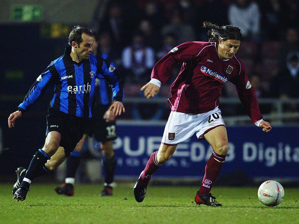 Cobblers midfielder Chris Hargreaves holds off current Rotherham boss Paul Warne during the original tie at Sixfields.