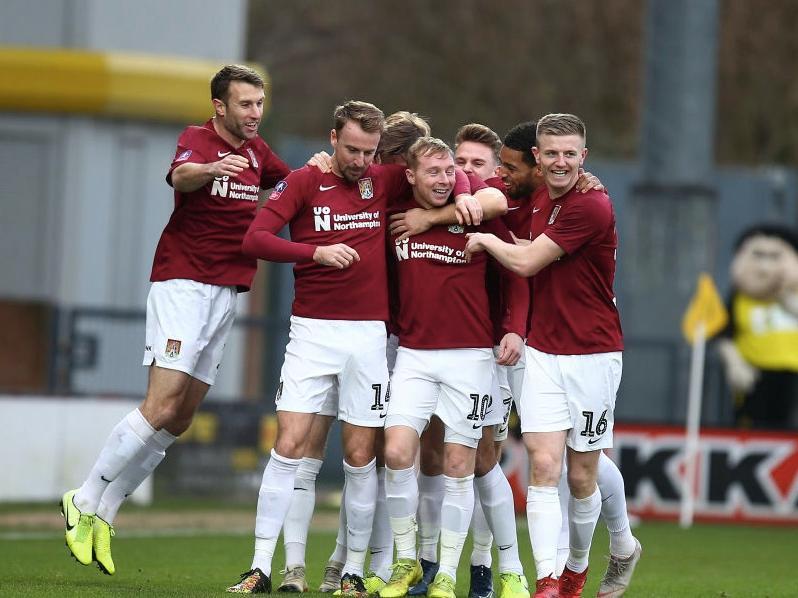 Nicky Adams gets the congratulations after steering the Cobblers into an early lead at Burton on Sunday. Pictures: Pete Norton