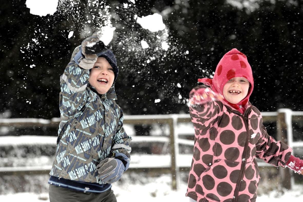 Children throw snowballs