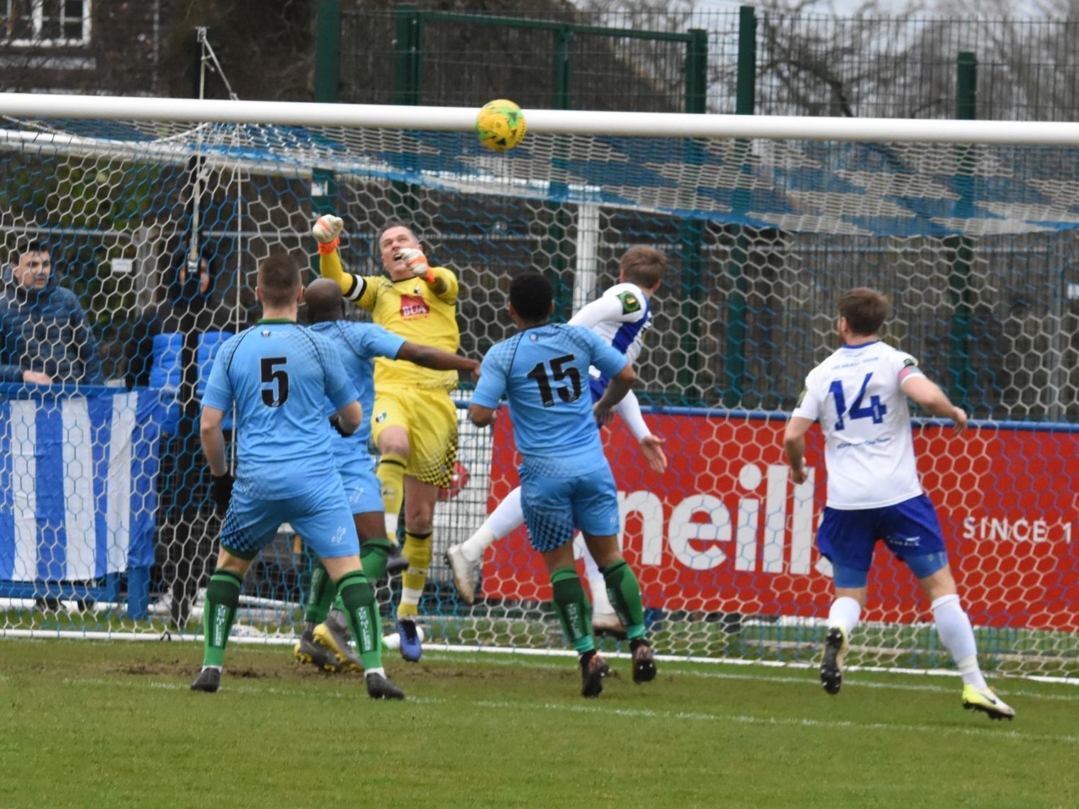 Callum Saunders heads the ball towards the goal.