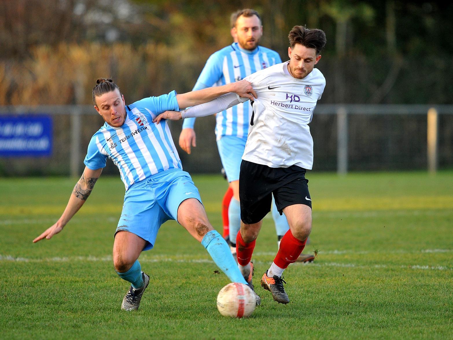 Adam Hunt battles with an AFC Uckfield Town player for the ball