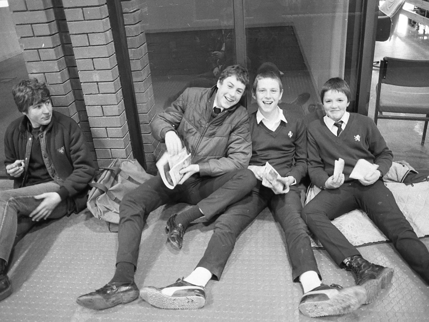 Four youngsters relaxing enjoying their chips