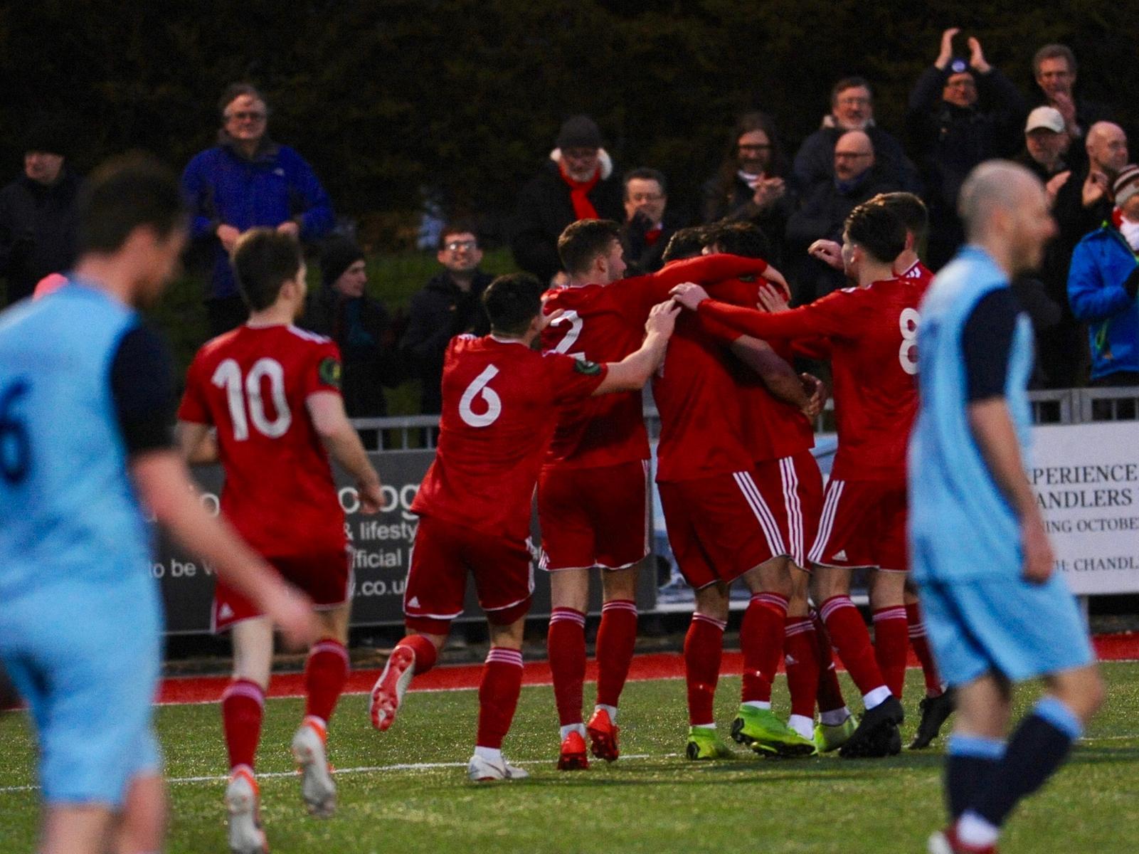 Worthing players celebrate the second goal